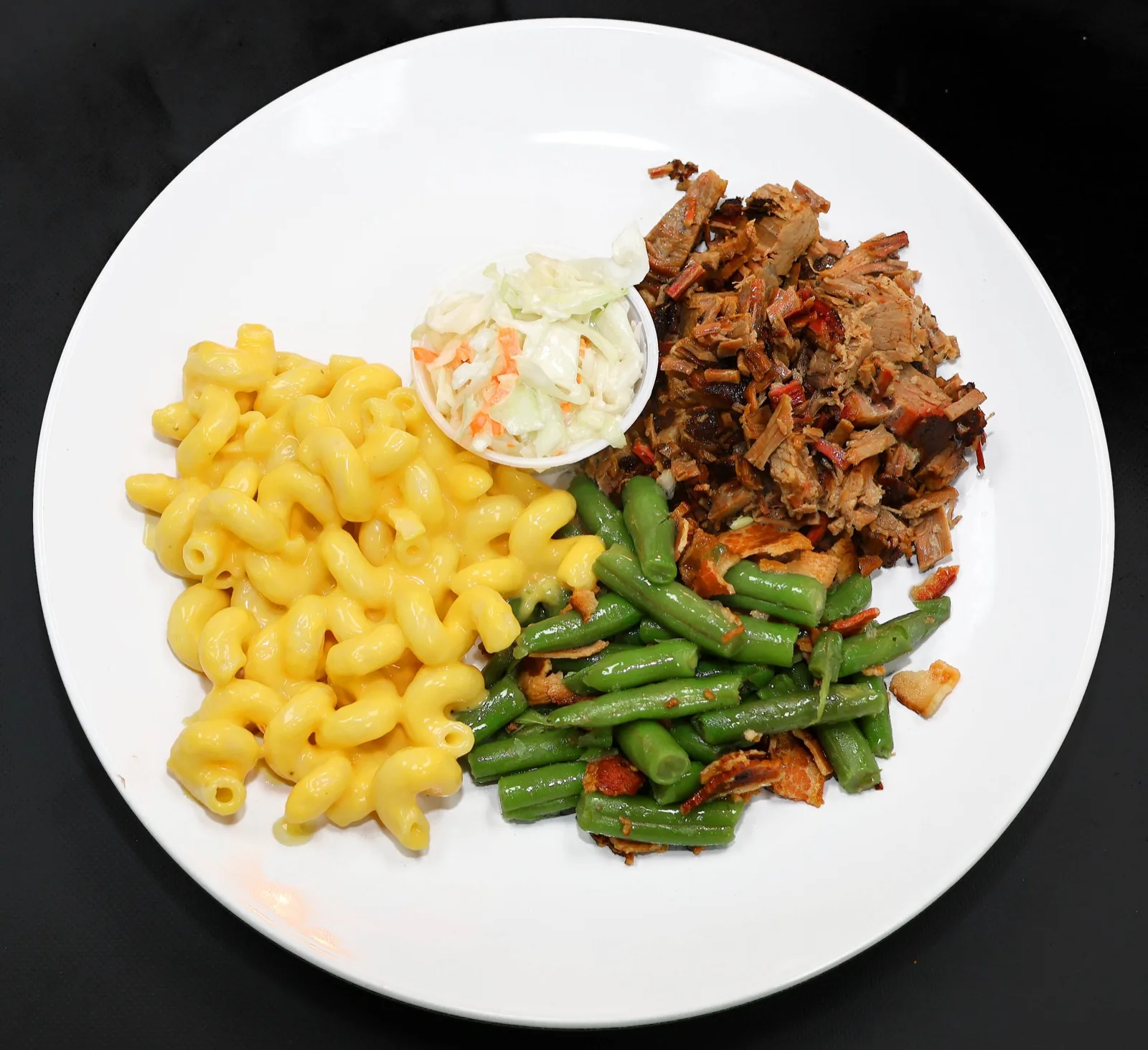 Plate of pulled pork, mac and cheese, green beans, and coleslaw at The Venue Clermont